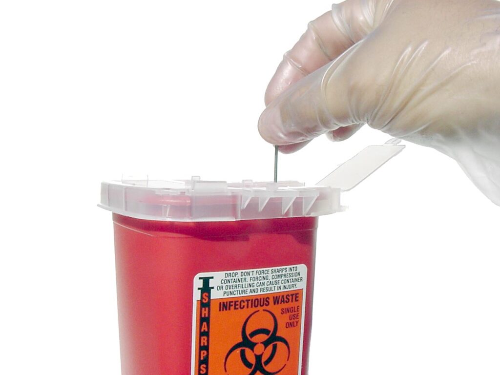 Disposing needle in sharps containers